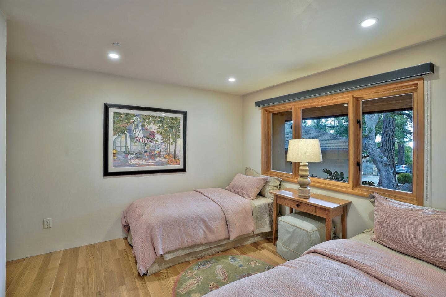 24651 Cabrillo Street Carmel, CA 93923 - Photo 28 of 42 a bedroom with bed and a large window