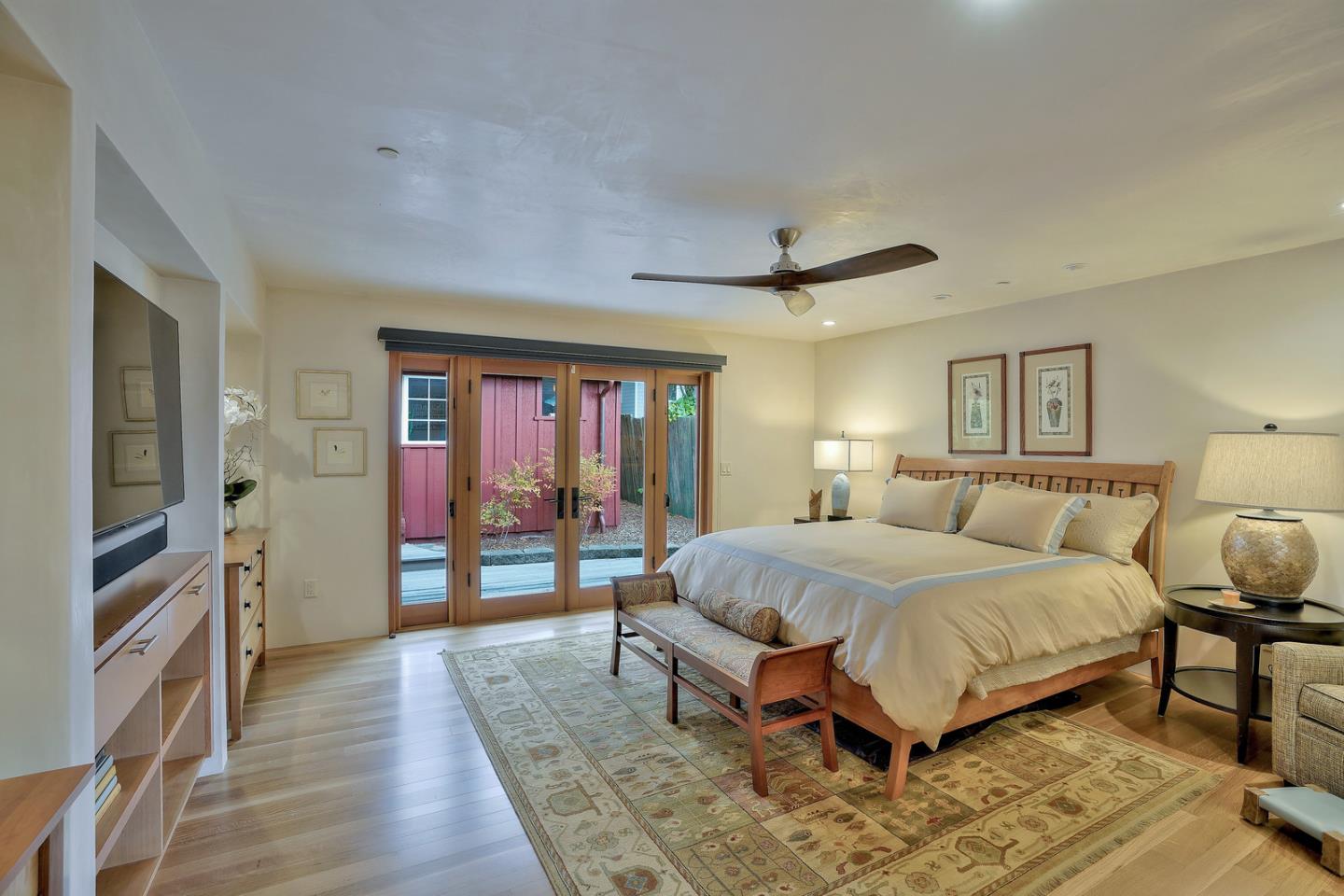 24651 Cabrillo Street Carmel, CA 93923 - Photo 30 of 42 a spacious bedroom with a bed and wooden floor