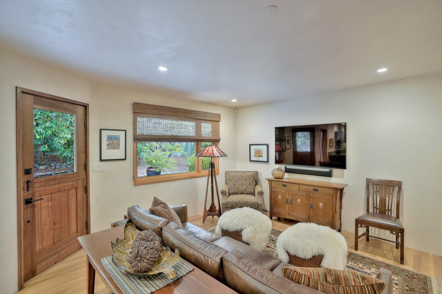 24651 Cabrillo Street Carmel, CA 93923 - Photo 33 of 42 a living room with furniture and a flat screen tv