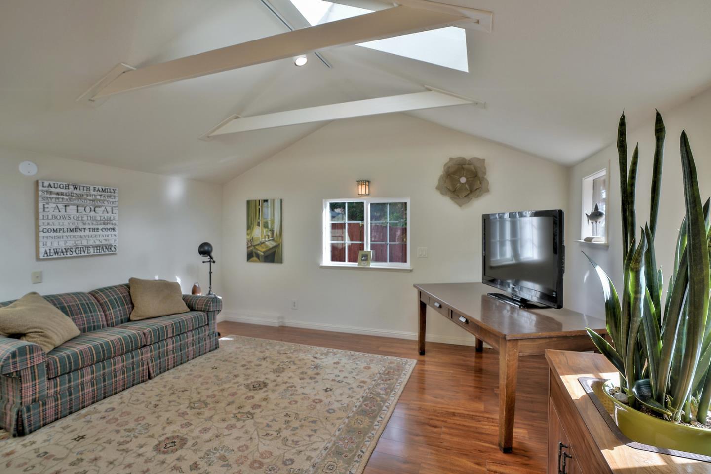 24651 Cabrillo Street Carmel, CA 93923 - Photo 37 of 42 a living room with furniture and a flat screen tv