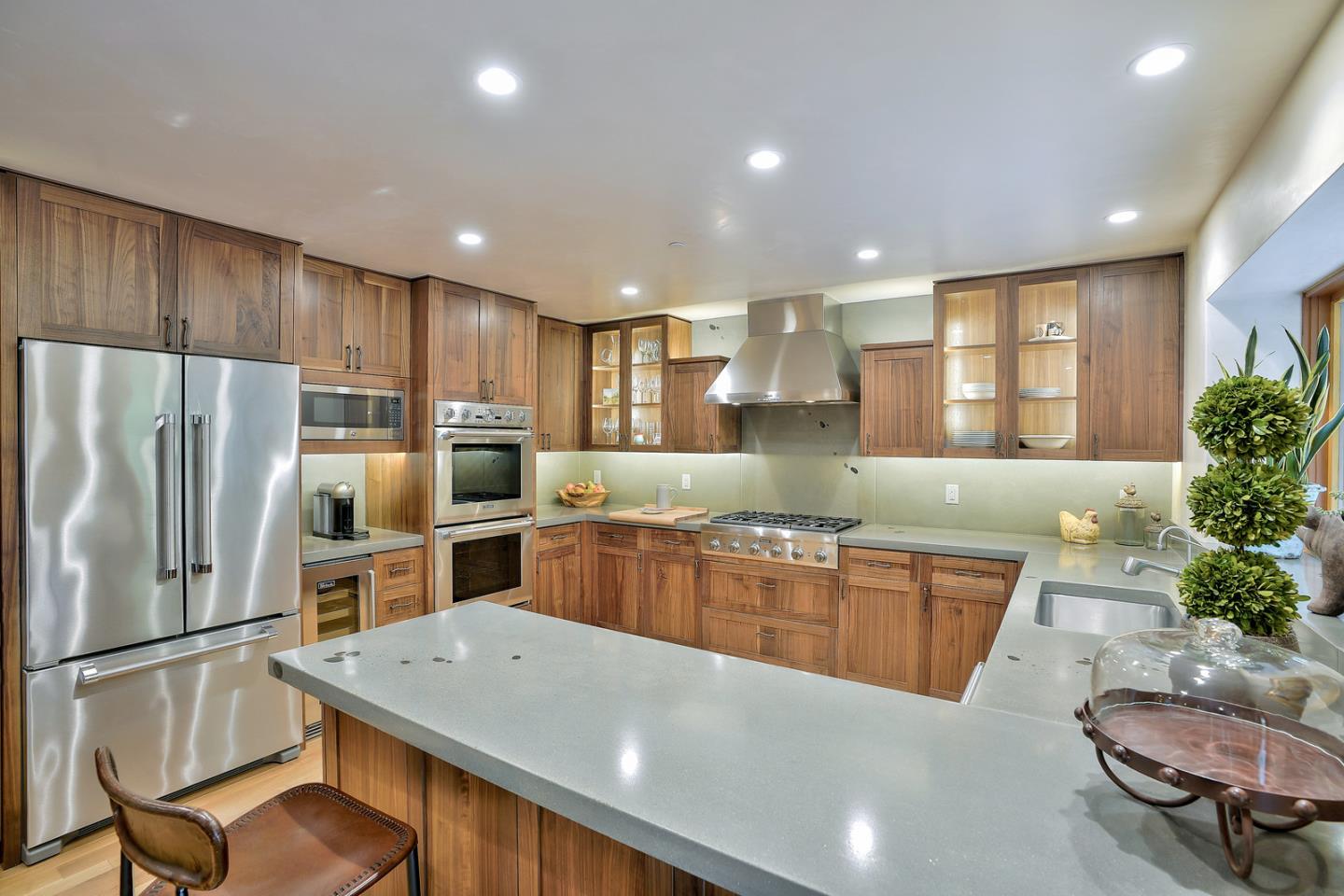 24651 Cabrillo Street Carmel, CA 93923 - Photo 5 of 42 a kitchen with stainless steel appliances granite countertop a refrigerator a sink dishwasher a stove and a refrigerator with wooden floor
