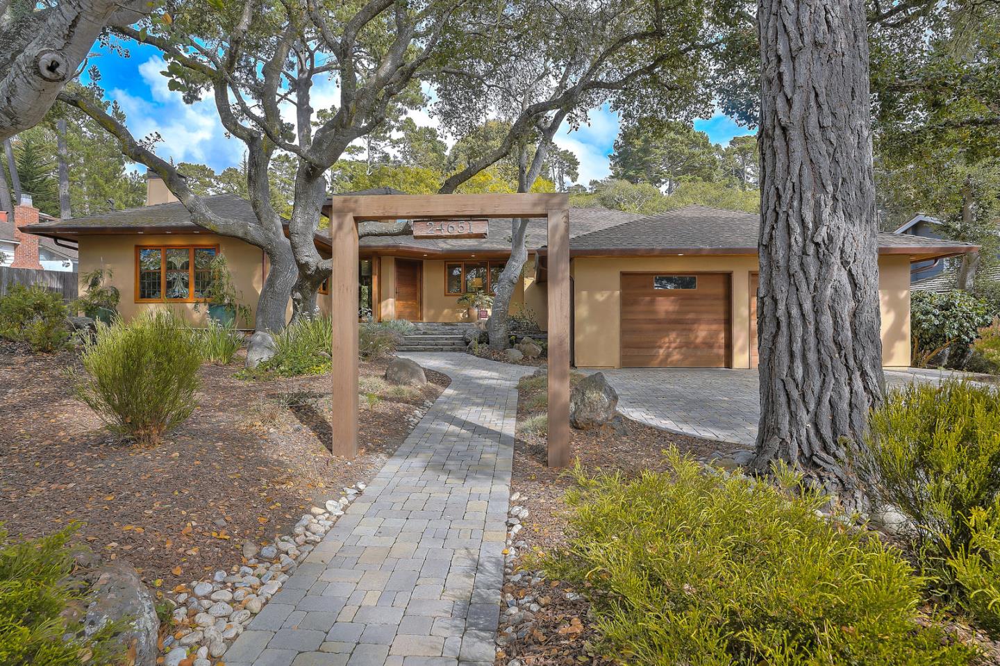 24651 Cabrillo Street Carmel, CA 93923 - Photo 6 of 42 a front view of a house with garden