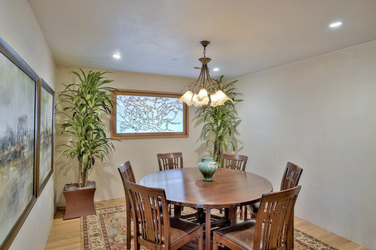 24651 Cabrillo Street Carmel, CA 93923 - Photo 10 of 42 a view of a dining room with furniture and chandelier