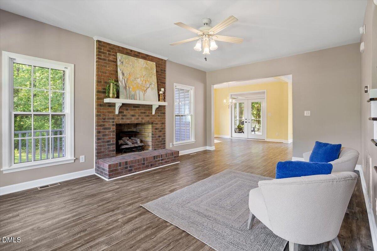 7505 Penny Road Raleigh, NC 27606 - Photo 10 of 35 a living room with furniture a large window and a fireplace