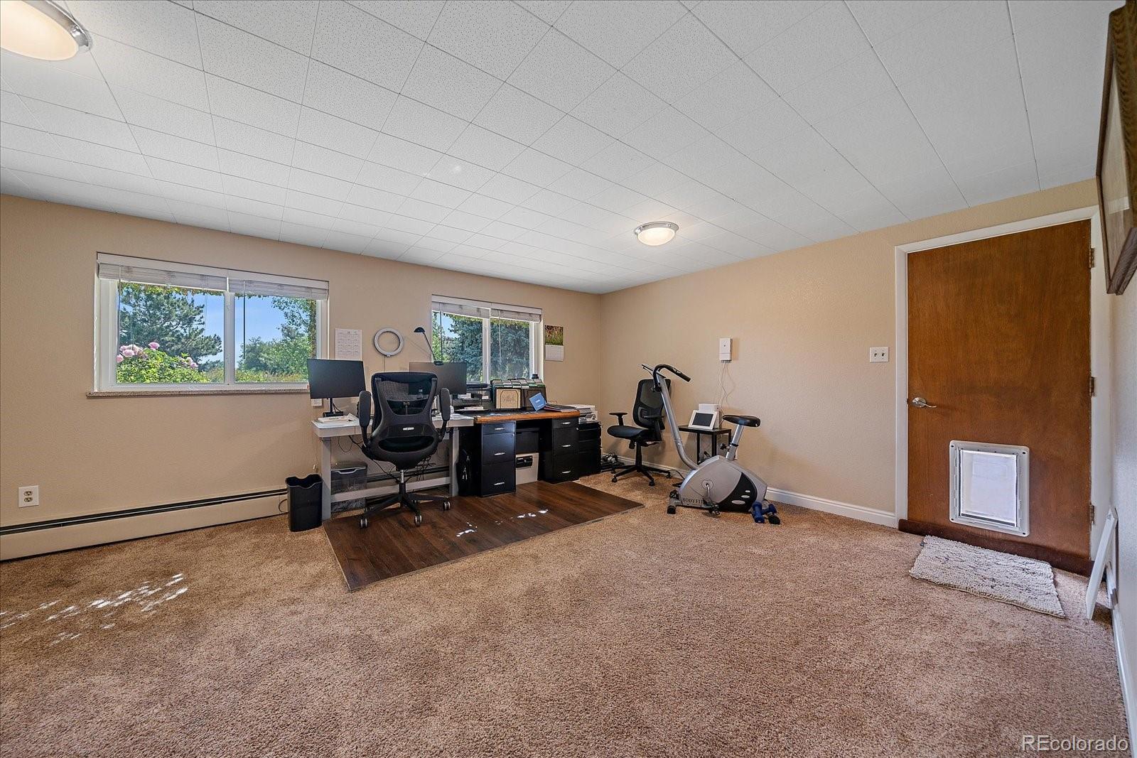 930 Reed Court Lakewood, CO 80214 - Photo 31 of 41 a room with furniture a window and gym equipment