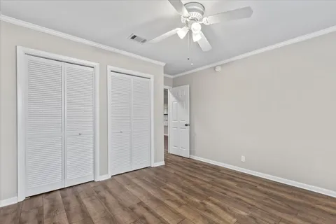 an empty room with a ceiling fan and a window