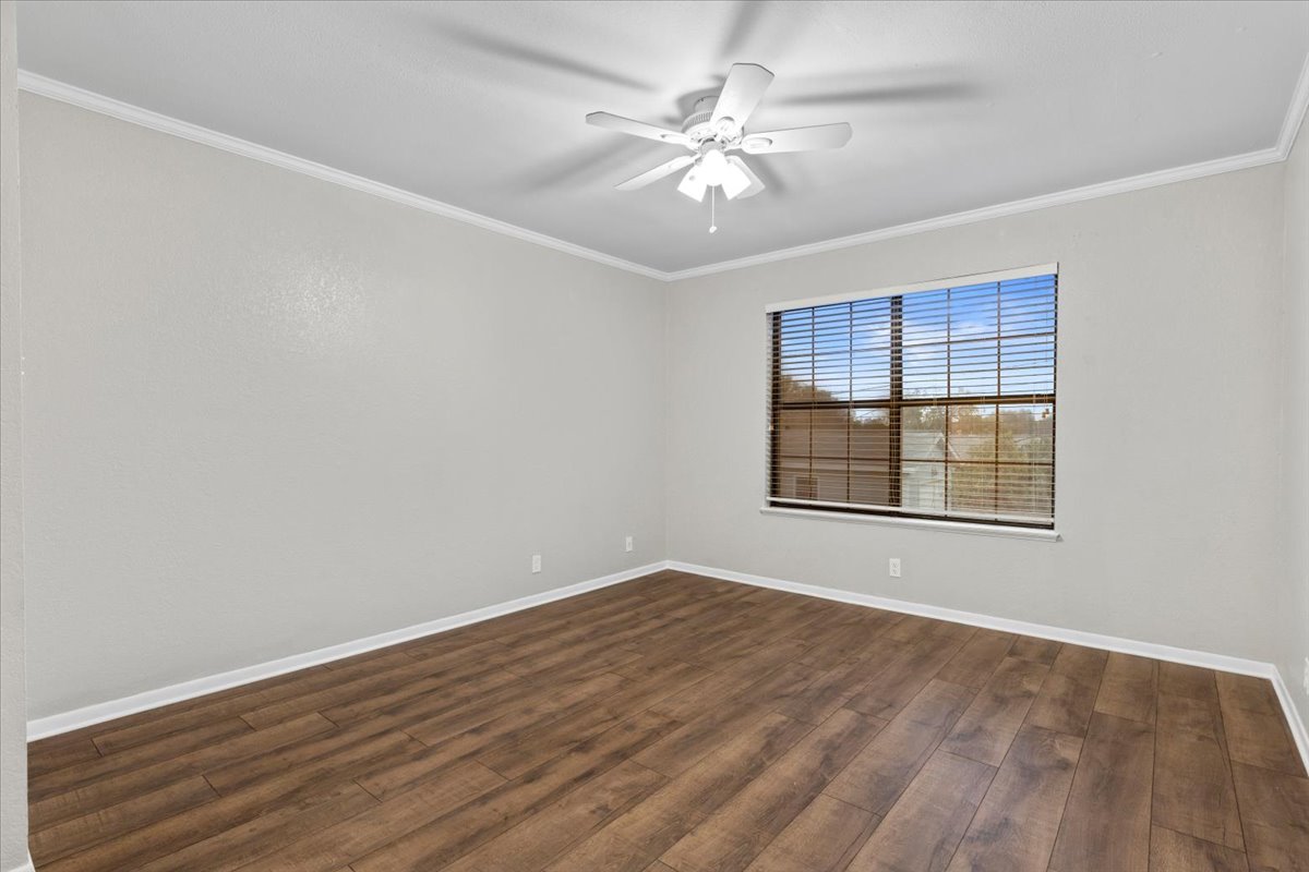 201 East Noton Street, Unit 104 Pflugerville, TX 78660 - Photo 20 of 35 wooden floor in an empty room with a window