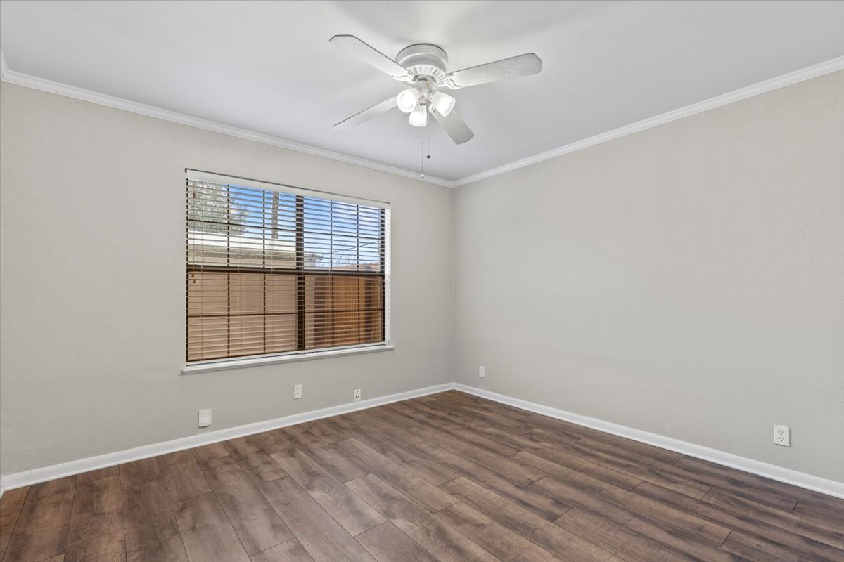 201 East Noton Street, Unit 104 Pflugerville, TX 78660 - Photo 22 of 35 wooden floor in an empty room with a window
