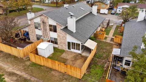 an aerial view of residential houses with outdoor space