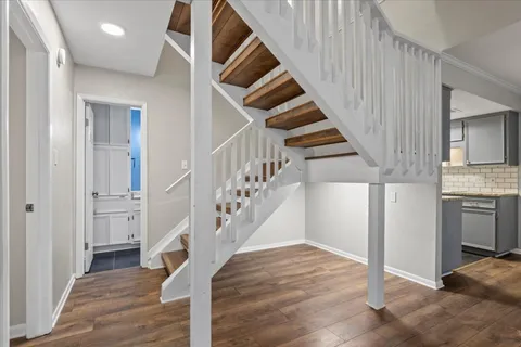a view of entryway and hall with wooden floor