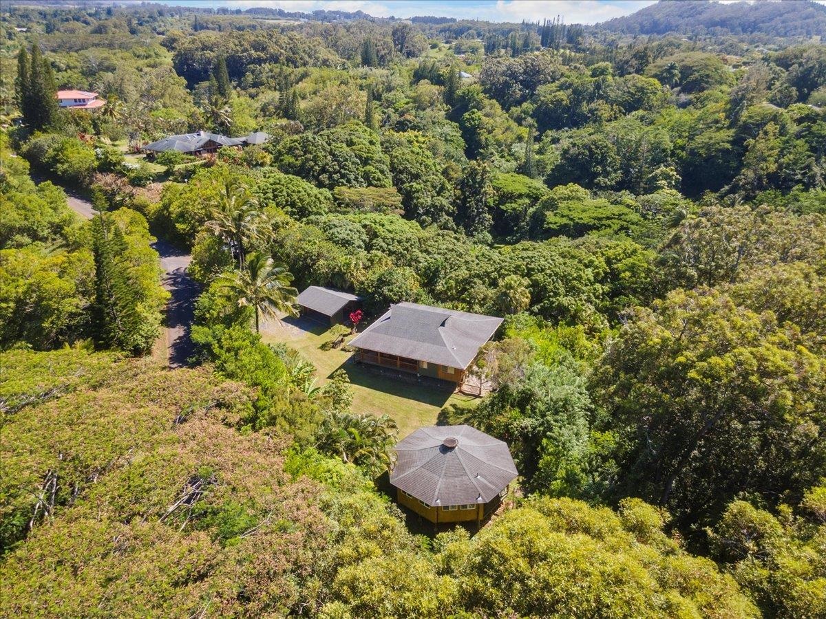 an aerial view of a house with a yard