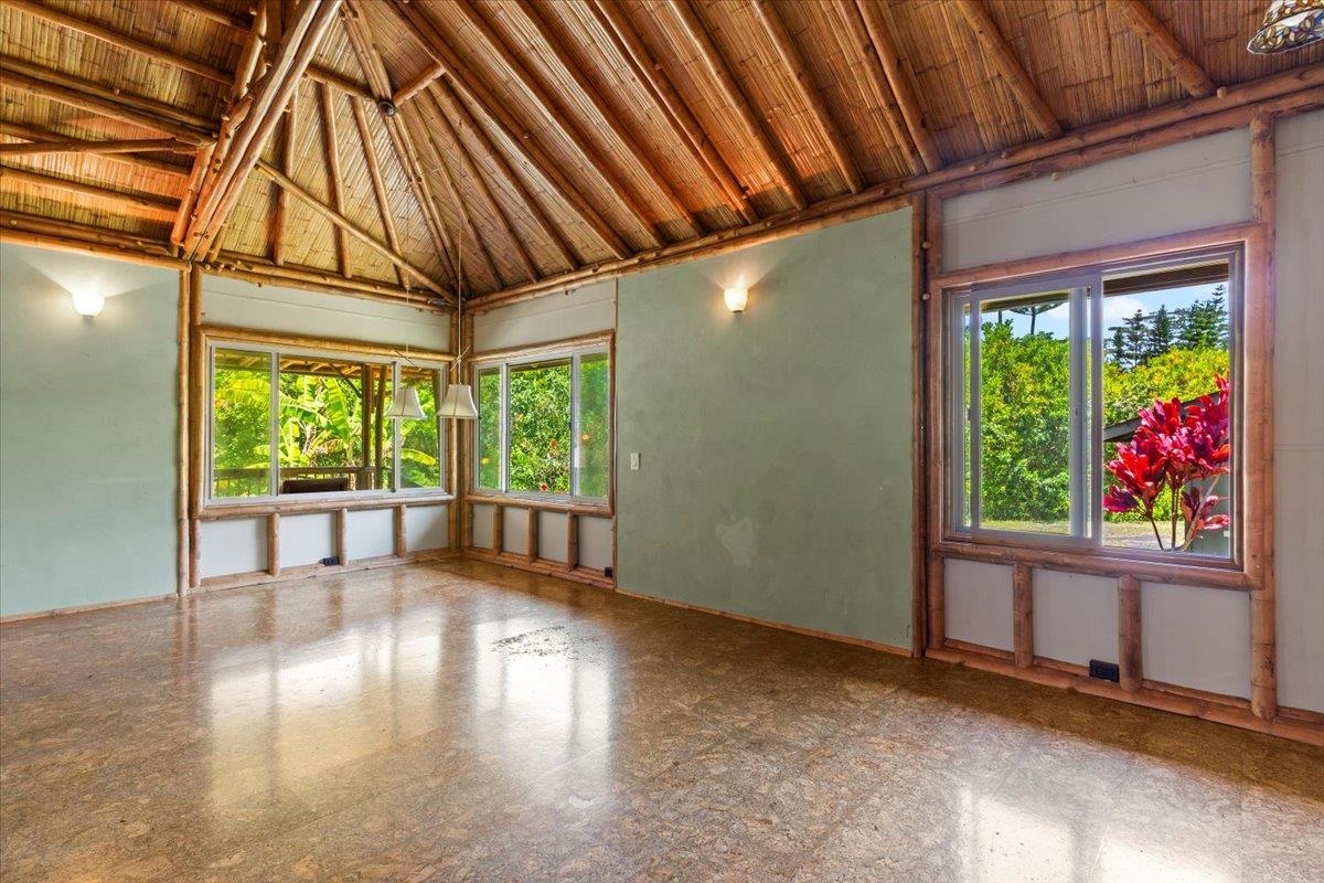 590 East Kuiaha Road Haiku, HI 96708 - Photo 17 of 42 a view of an empty room with wooden floor and a window