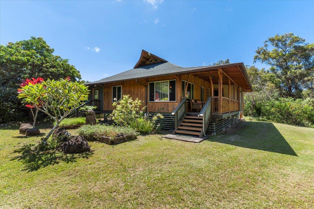 590 East Kuiaha Road Haiku, HI 96708 - Photo 2 of 42 a front view of a house with a yard