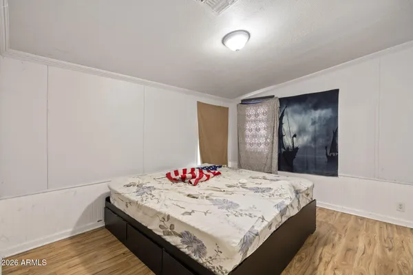 a bedroom with a bed and a dresser
