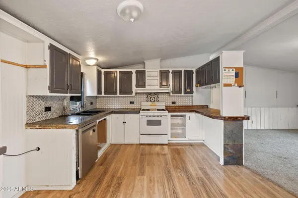 a kitchen with stainless steel appliances granite countertop a sink and cabinets