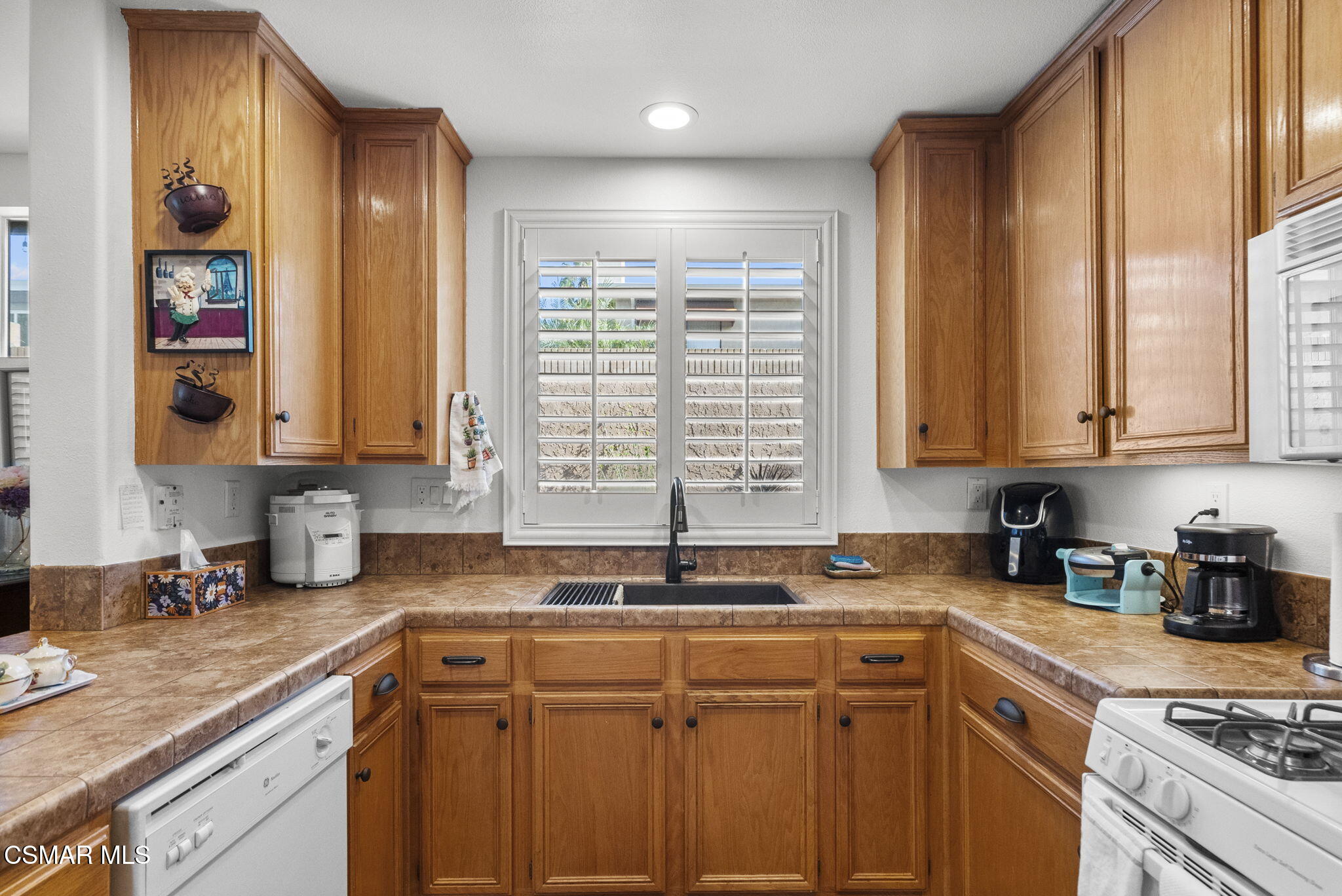 2046 Freesia Avenue Simi Valley, CA 93063 - Photo 13 of 33 a kitchen with stainless steel appliances granite countertop a sink a stove and cabinets