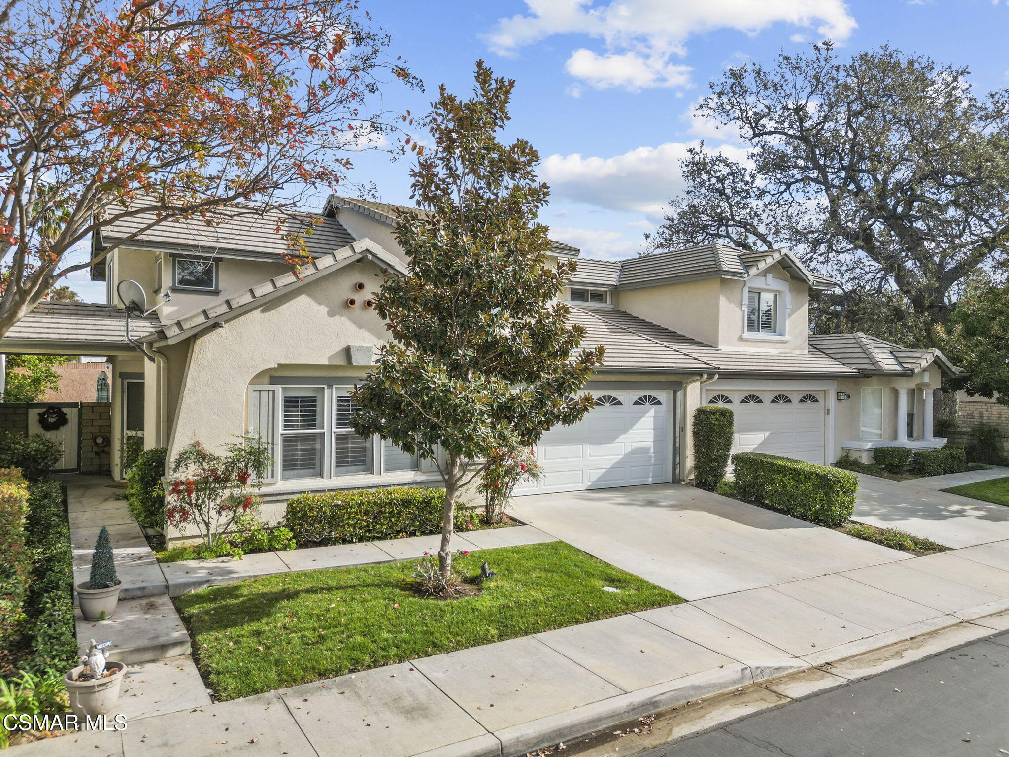 2046 Freesia Avenue Simi Valley, CA 93063 - Photo 2 of 33 a front view of a house with a yard and trees