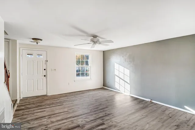 wooden floor in an empty room with a window