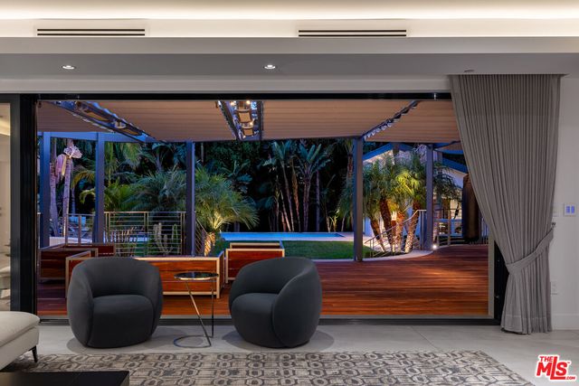 a living room with couch and a floor to ceiling window