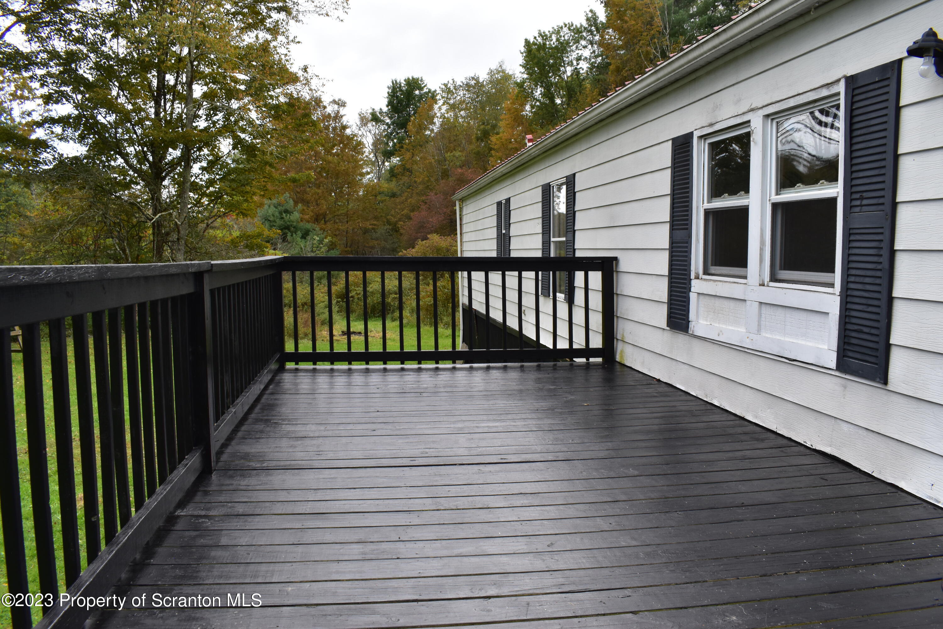 1258 Jennings Road Springville, PA 18844 - Photo 4 of 32 a view of deck with large windows and wooden floor