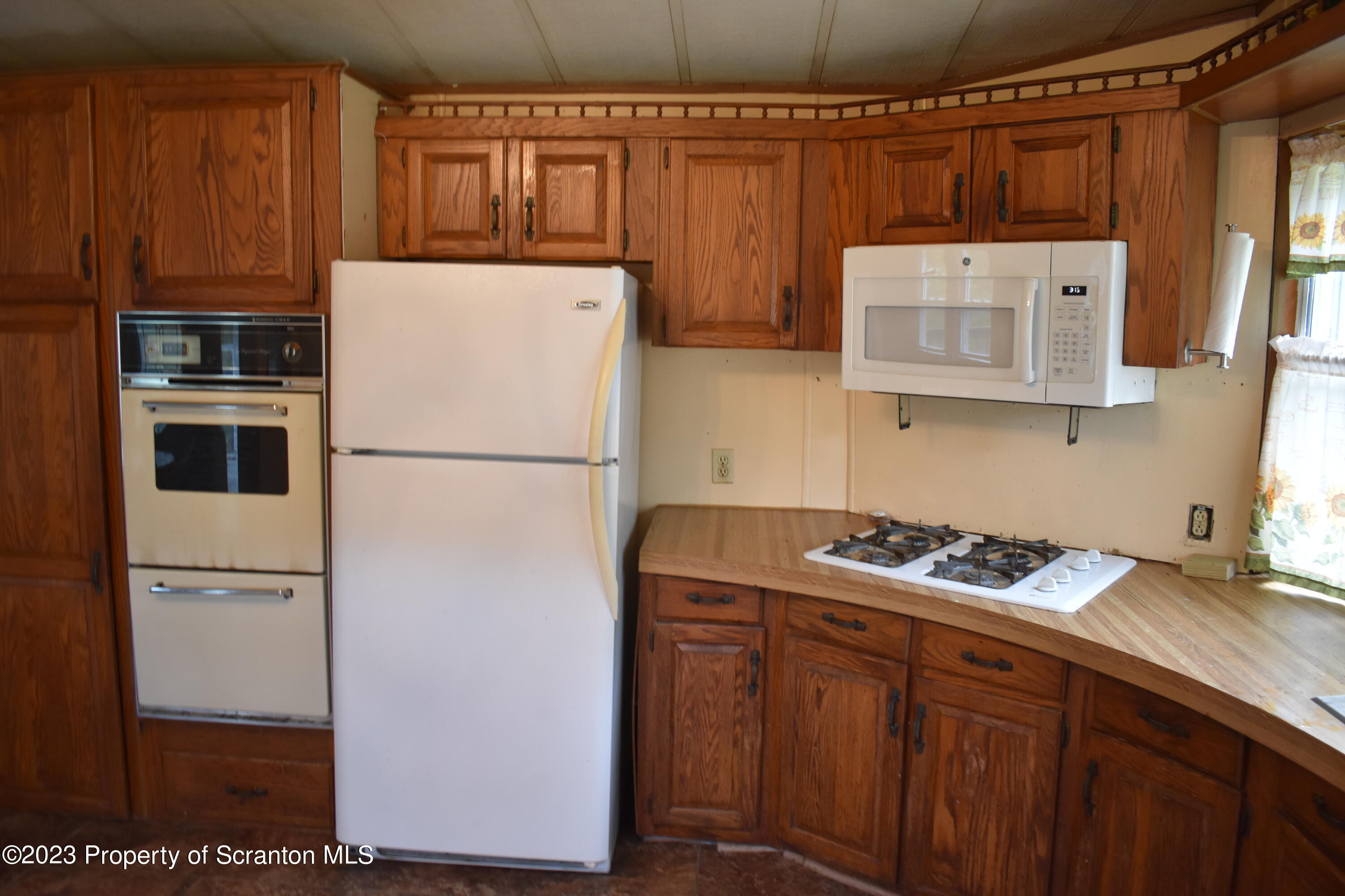1258 Jennings Road Springville, PA 18844 - Photo 8 of 32 a kitchen with stainless steel appliances granite countertop a refrigerator a stove and a sink