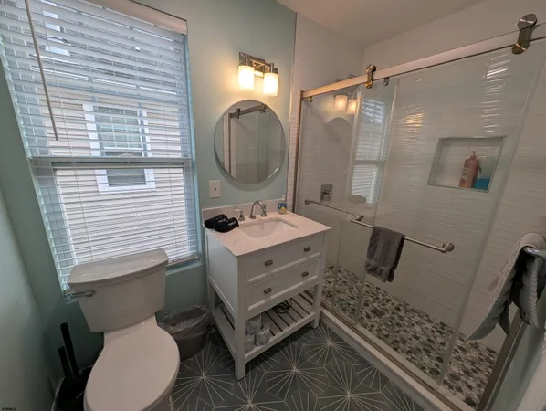 a bathroom with a sink mirror vanity and toilet