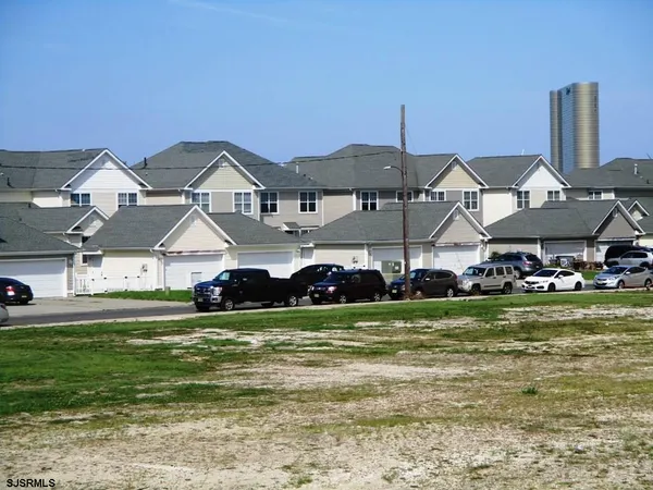 a view of a house with a big yard and sitting area