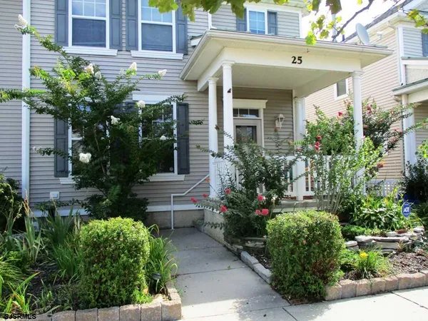 a view of a house with potted plants