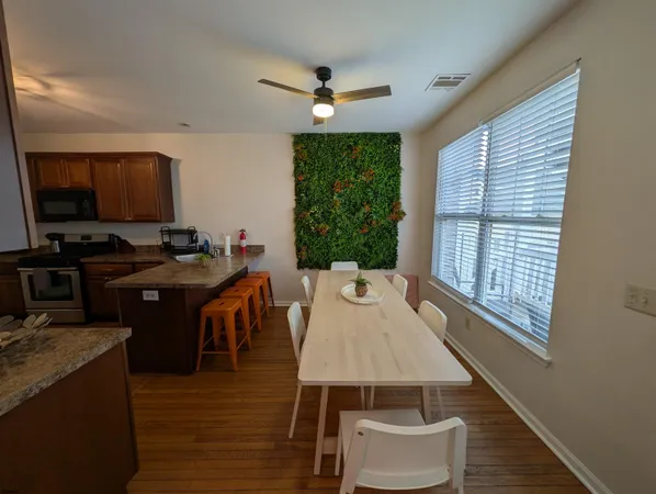 a view of a dining room with furniture and wooden floor