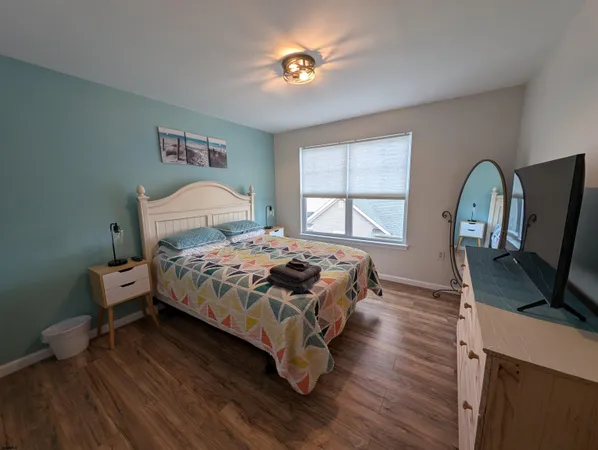 a bedroom with a bed and a flat screen tv