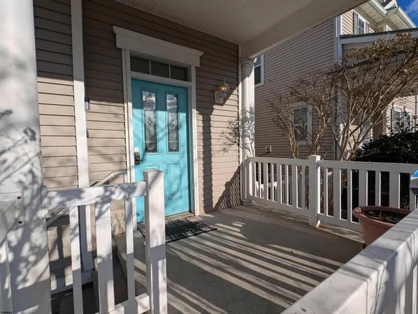 a view of a balcony with wooden floor and fence