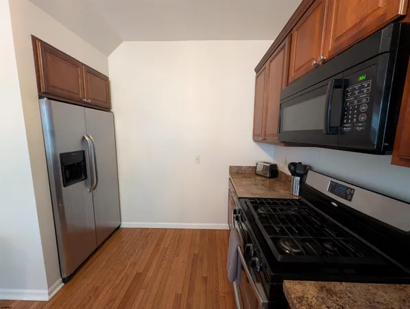 a kitchen with wooden floors and a stove