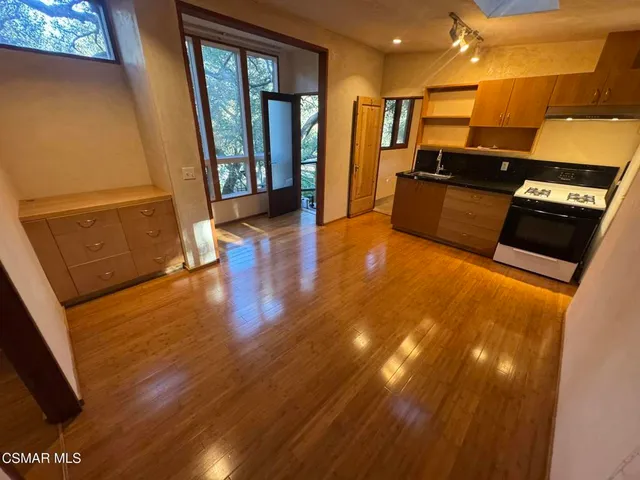 a view of a living room with wooden floor
