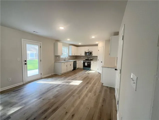 a view of kitchen and wooden floor