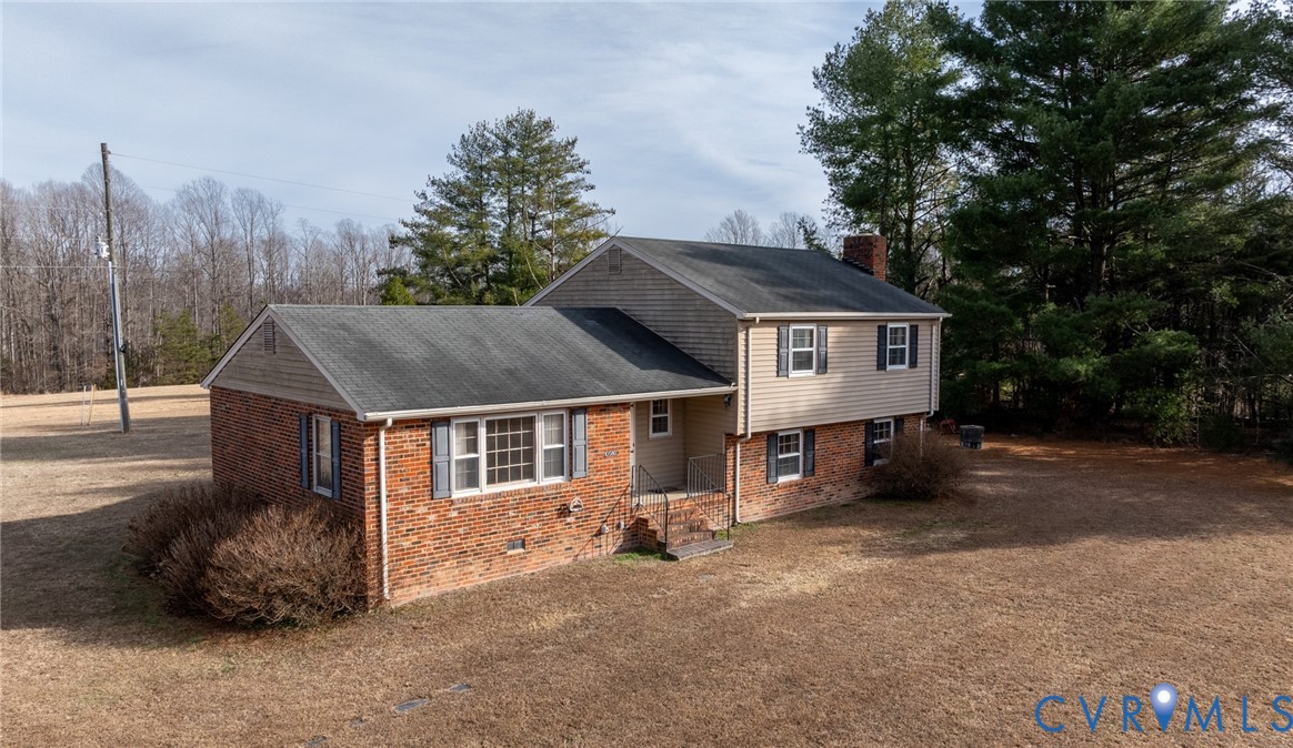 a view of a house with a yard and sitting area