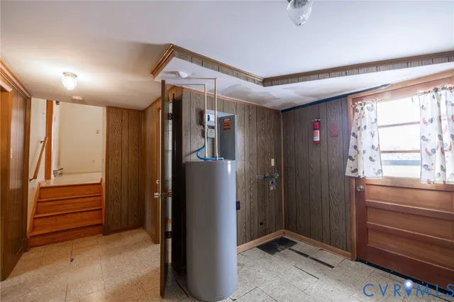 a view of hallway with stairs and furniture