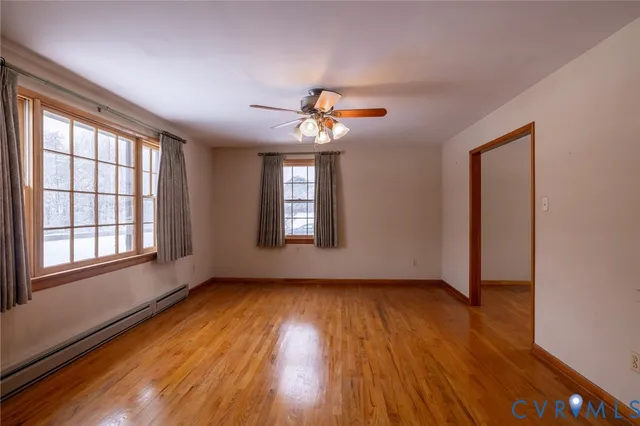wooden floor in an empty room with a window