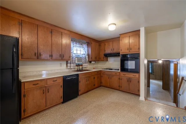 a kitchen with cabinets a sink and stainless steel appliances