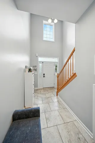 a living room with furniture a flat screen tv and a window