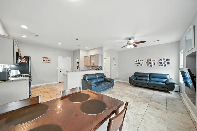 a kitchen with granite countertop cabinets a table and chairs in it
