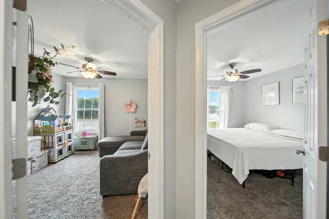 a spacious bedroom with a bed and a ceiling fan