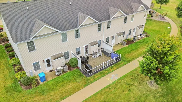 an aerial view of a house with a garden and deck