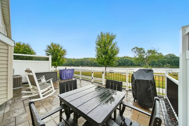 a view of a patio with table and chairs and a barbeque