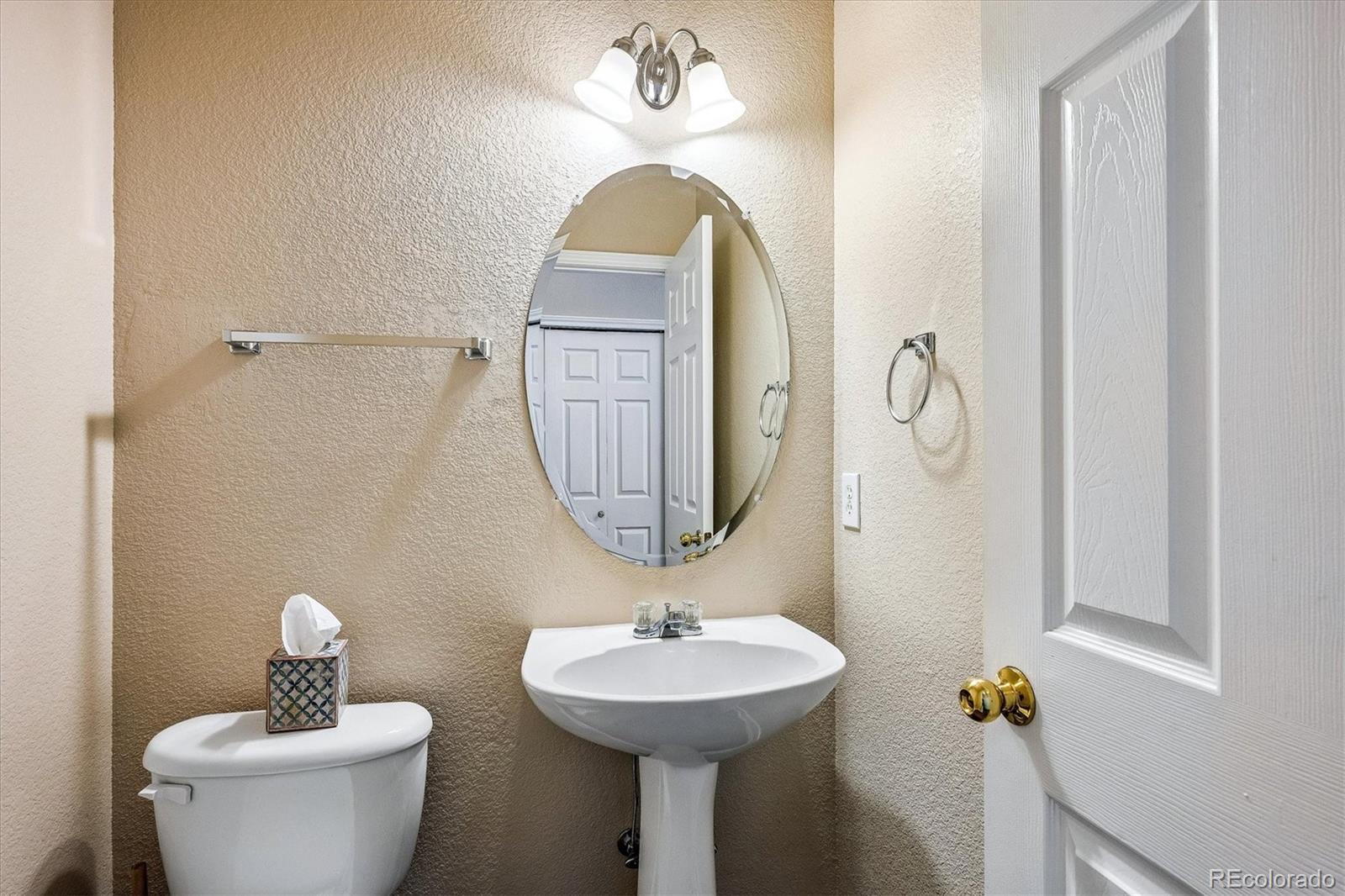 4545 South Taft Way Morrison, CO 80465 - Photo 11 of 19 a bathroom with a sink a mirror and a toilet