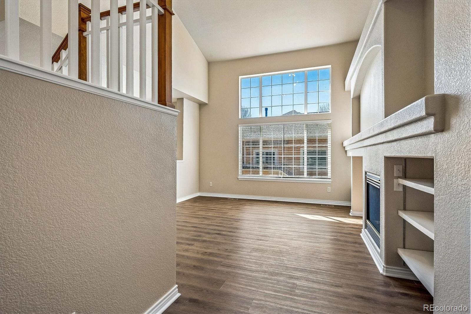4545 South Taft Way Morrison, CO 80465 - Photo 3 of 19 a view of an empty room with wooden floor and a window