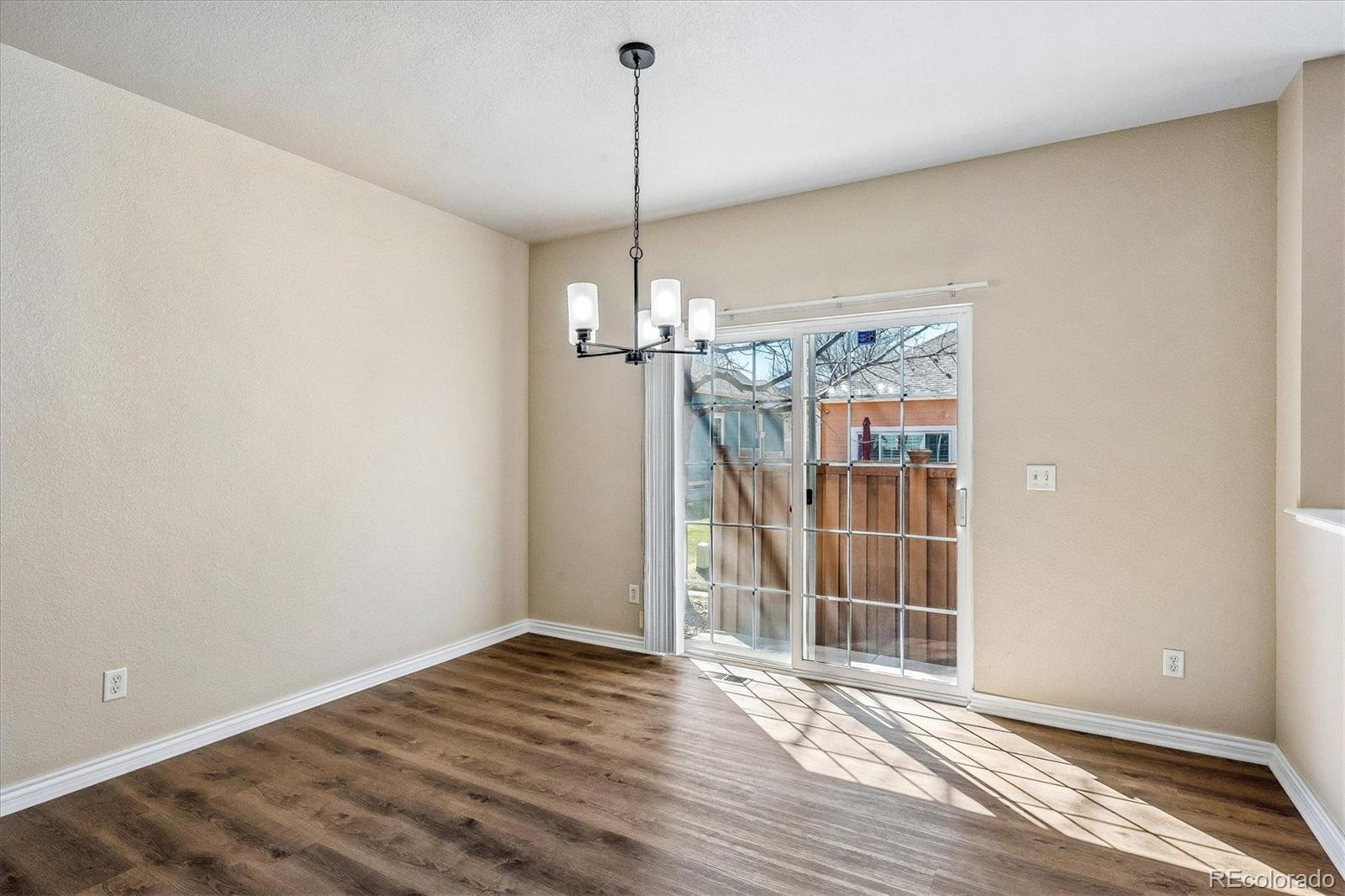 4545 South Taft Way Morrison, CO 80465 - Photo 9 of 19 a view of a room with wooden floor a ceiling fan and window