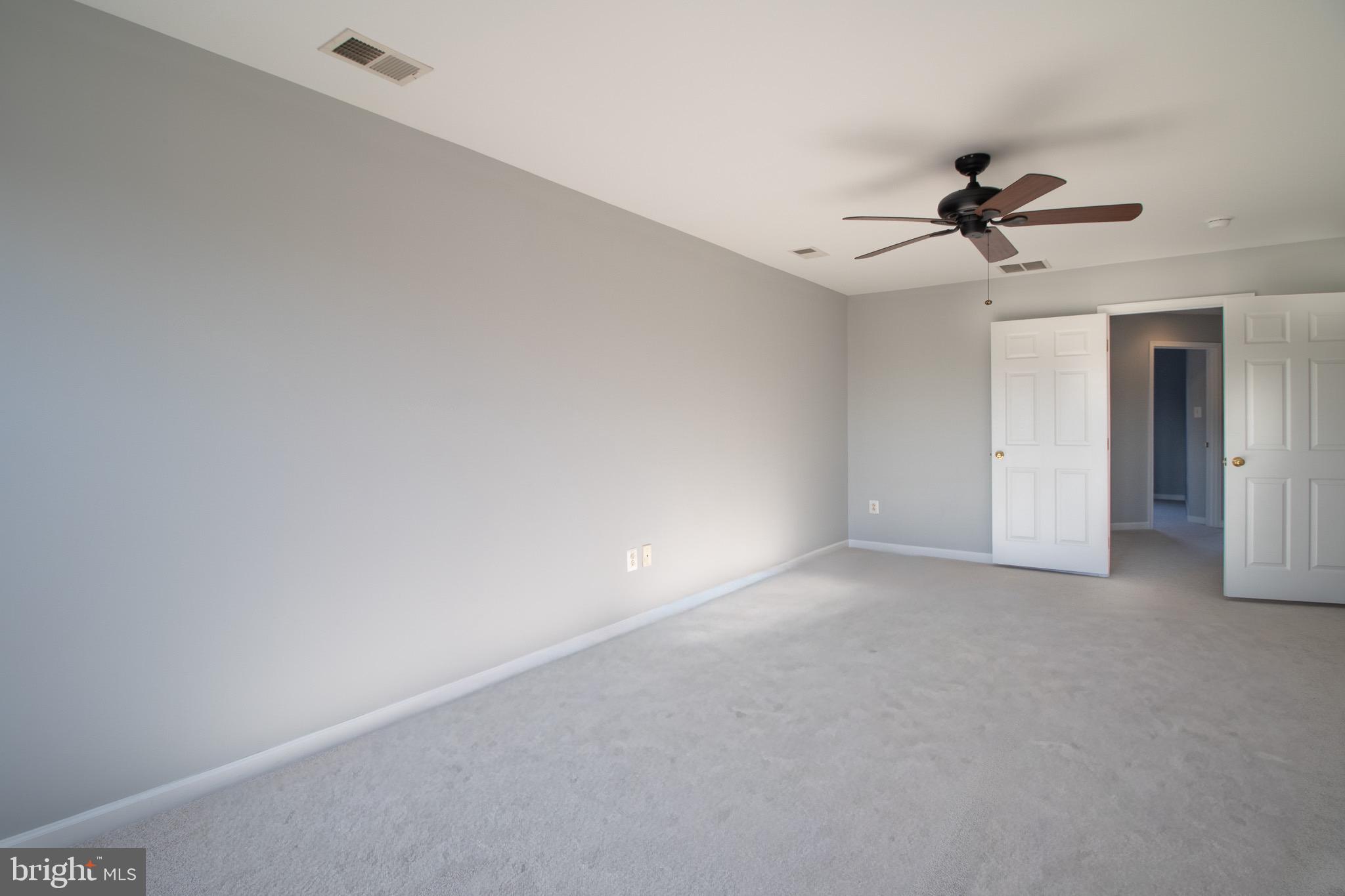 98 Lullwater Way Falling Waters, WV 25419 - Photo 23 of 43 a view of a room with a ceiling fan and carpet