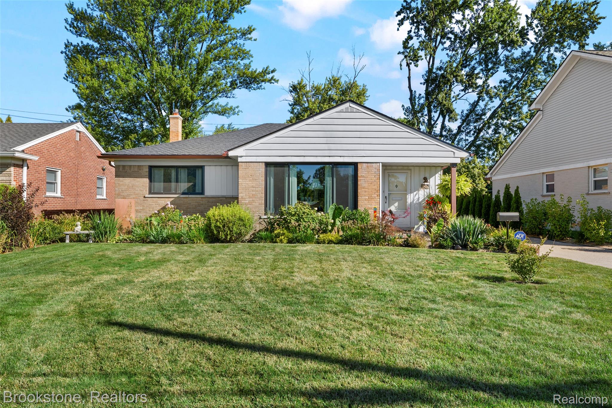 18474 Beverly Road Franklin, MI 48025 - Photo 1 of 38 View of front of house with brick siding, a front lawn, and a chimney
