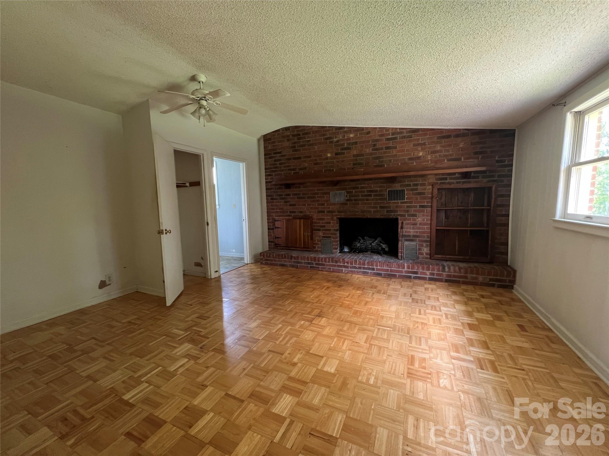 4405 Maple Creek Road Rutherfordton, NC 28139 - Photo 14 of 32 wooden floor fireplace and windows in an empty room