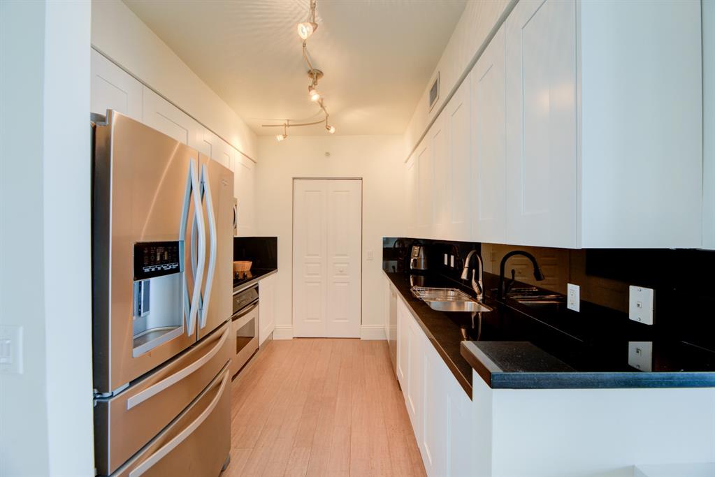 350 Southeast 2nd Street, Unit 1680 Fort Lauderdale, FL 33301 - Photo 11 of 35 a kitchen with stainless steel appliances granite countertop a refrigerator and a stove